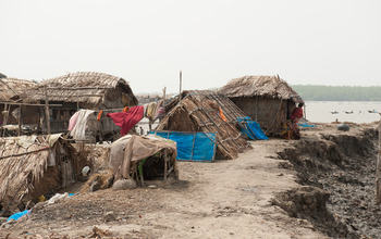 Bangladesh villagers live atop a levee that's rapidly eroding following a series of river floods.